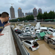 People look out at cars sitting in floodwaters after heavy rains hit the city of Zhengzhou in China's central Henan province on July 21, 2021.